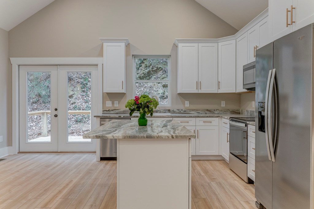 79 Logan Lane Ellijay, GA 30540 - Photo 27 of 56 a kitchen with stainless steel appliances granite countertop a refrigerator and a stove top oven