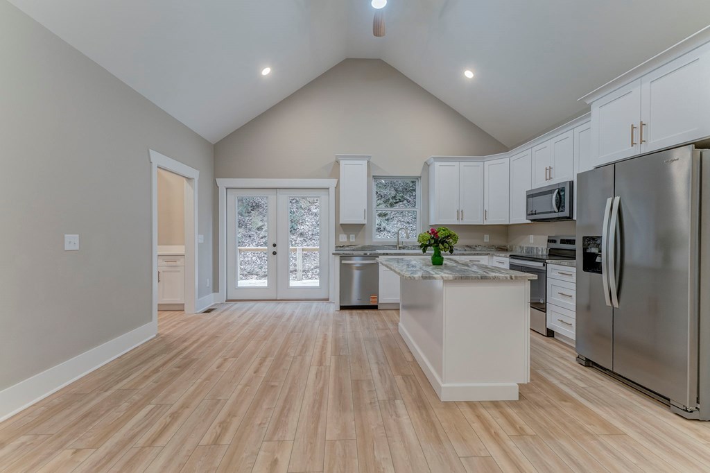 79 Logan Lane Ellijay, GA 30540 - Photo 28 of 56 a kitchen with a refrigerator a sink and cabinets