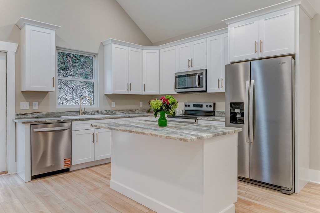 79 Logan Lane Ellijay, GA 30540 - Photo 30 of 56 a kitchen with stainless steel appliances granite countertop a refrigerator a stove a sink and white cabinets