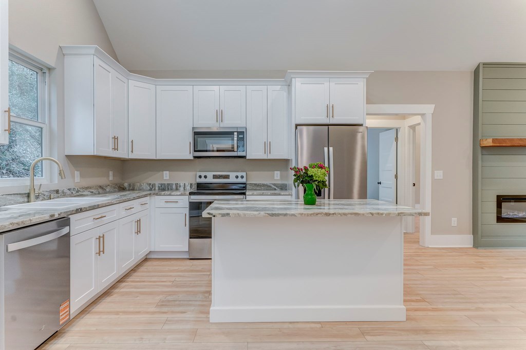 79 Logan Lane Ellijay, GA 30540 - Photo 31 of 56 a kitchen with granite countertop a refrigerator stove top oven and sink