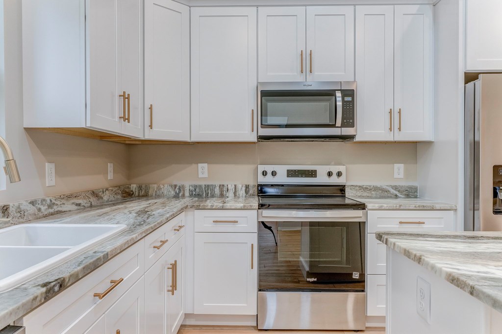 79 Logan Lane Ellijay, GA 30540 - Photo 32 of 56 a kitchen with granite countertop white cabinets and stainless steel appliances