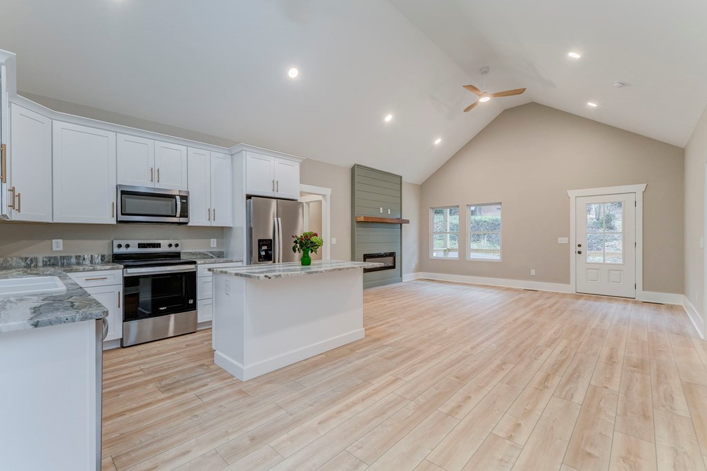 79 Logan Lane Ellijay, GA 30540 - Photo 33 of 56 a kitchen with granite countertop a stove a sink and a refrigerator