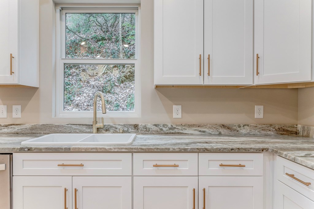 79 Logan Lane Ellijay, GA 30540 - Photo 34 of 56 a kitchen with granite countertop white cabinets and a window