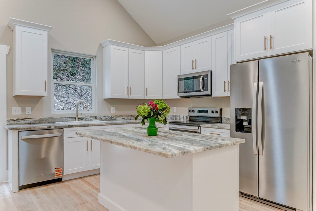 79 Logan Lane Ellijay, GA 30540 - Photo 38 of 56 a kitchen with stainless steel appliances granite countertop a refrigerator stove microwave and sink