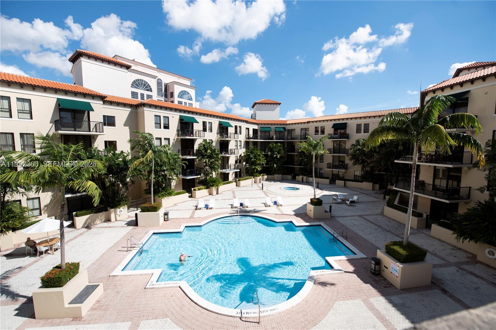 55 Merrick Way, Unit 702 Coral Gables, FL 33134 - Photo 16 of 17 a view of a house with backyard outdoor seating and swimming pool