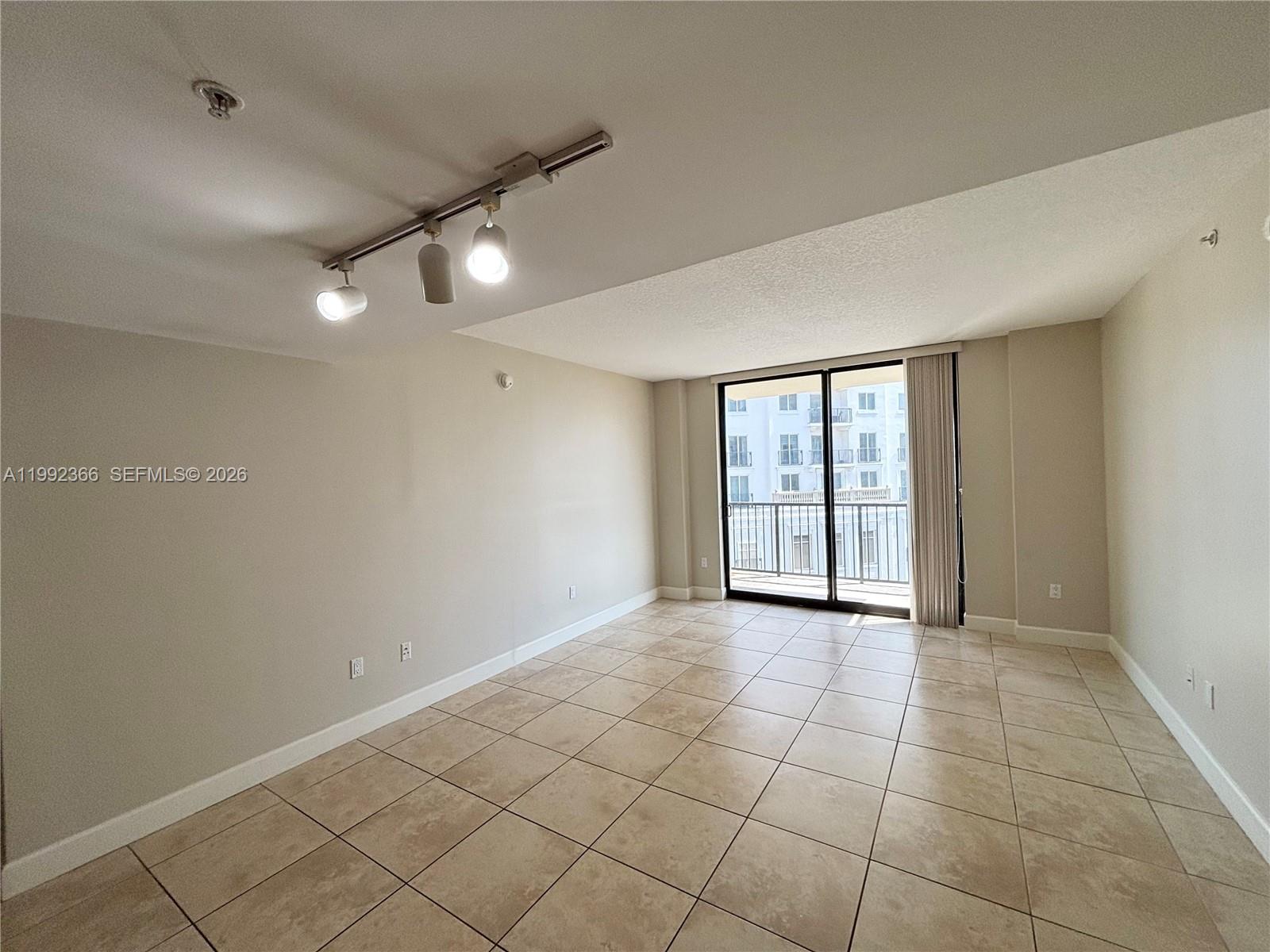 55 Merrick Way, Unit 702 Coral Gables, FL 33134 - Photo 3 of 17 a view of an empty room with a window