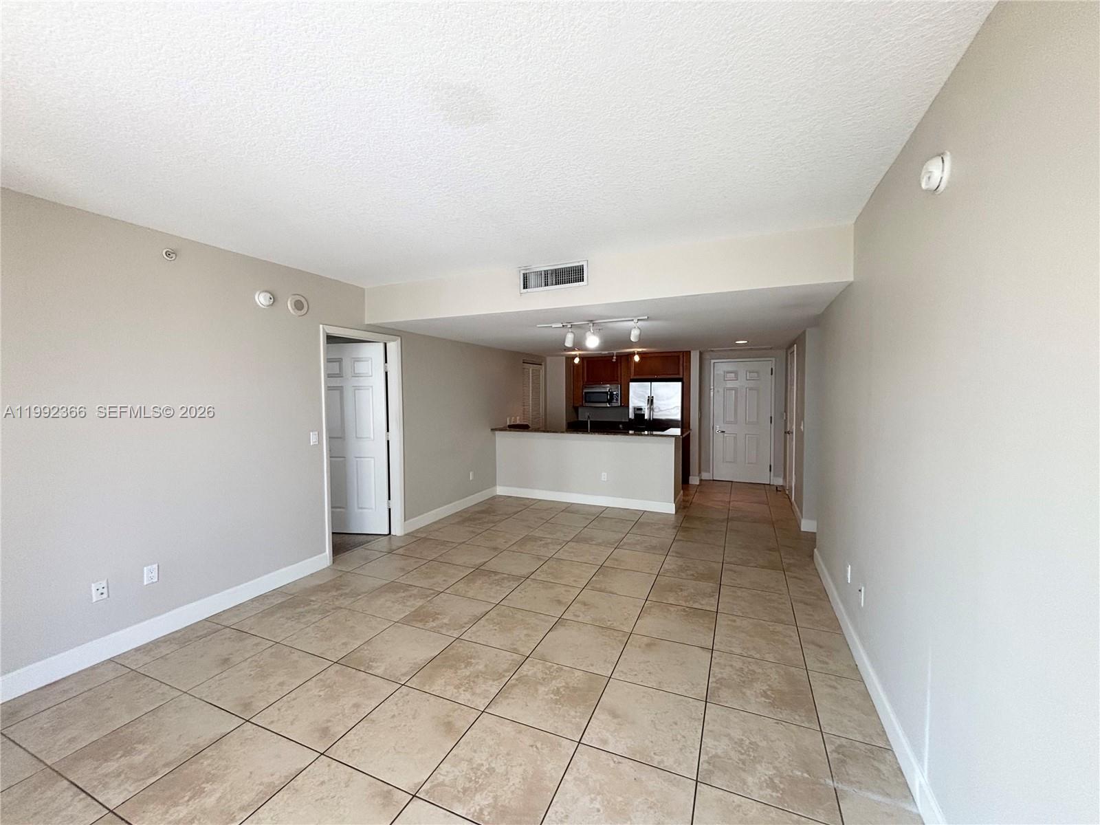 55 Merrick Way, Unit 702 Coral Gables, FL 33134 - Photo 4 of 17 a view of empty room with wooden floor