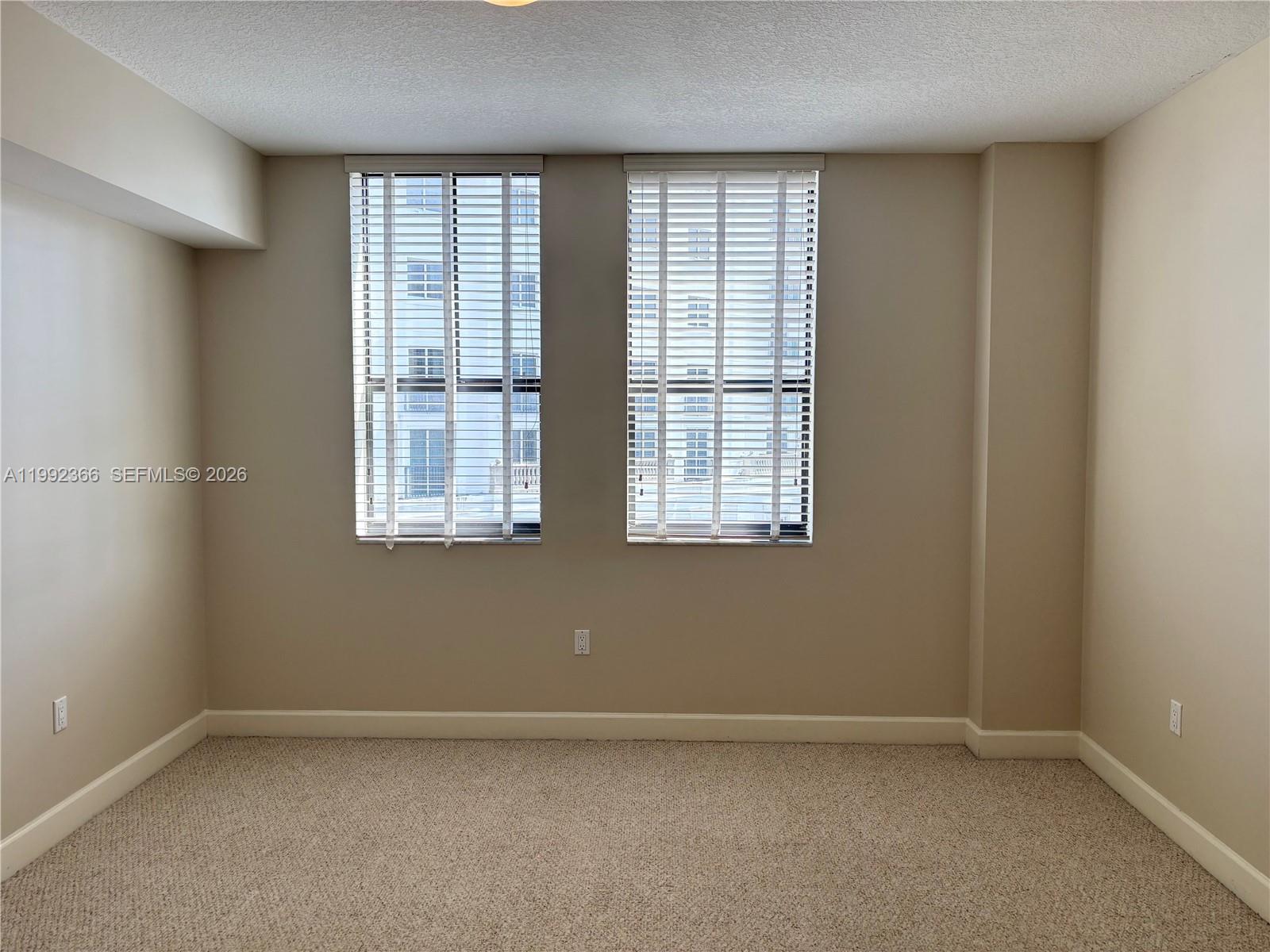 55 Merrick Way, Unit 702 Coral Gables, FL 33134 - Photo 7 of 17 an empty room with a window