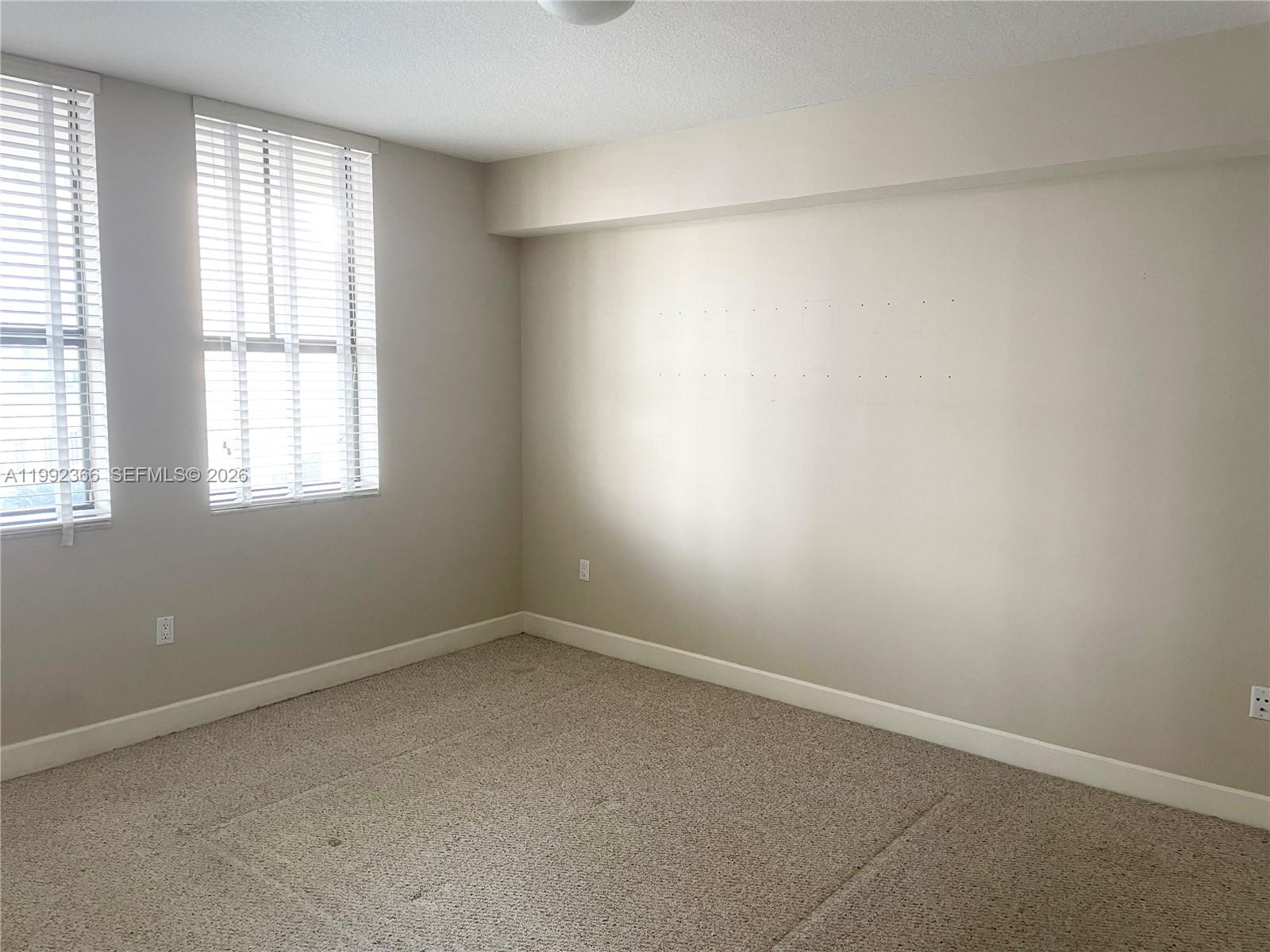 55 Merrick Way, Unit 702 Coral Gables, FL 33134 - Photo 8 of 17 an empty room with a window