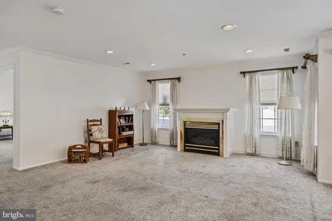 a view of a livingroom with a fireplace and window