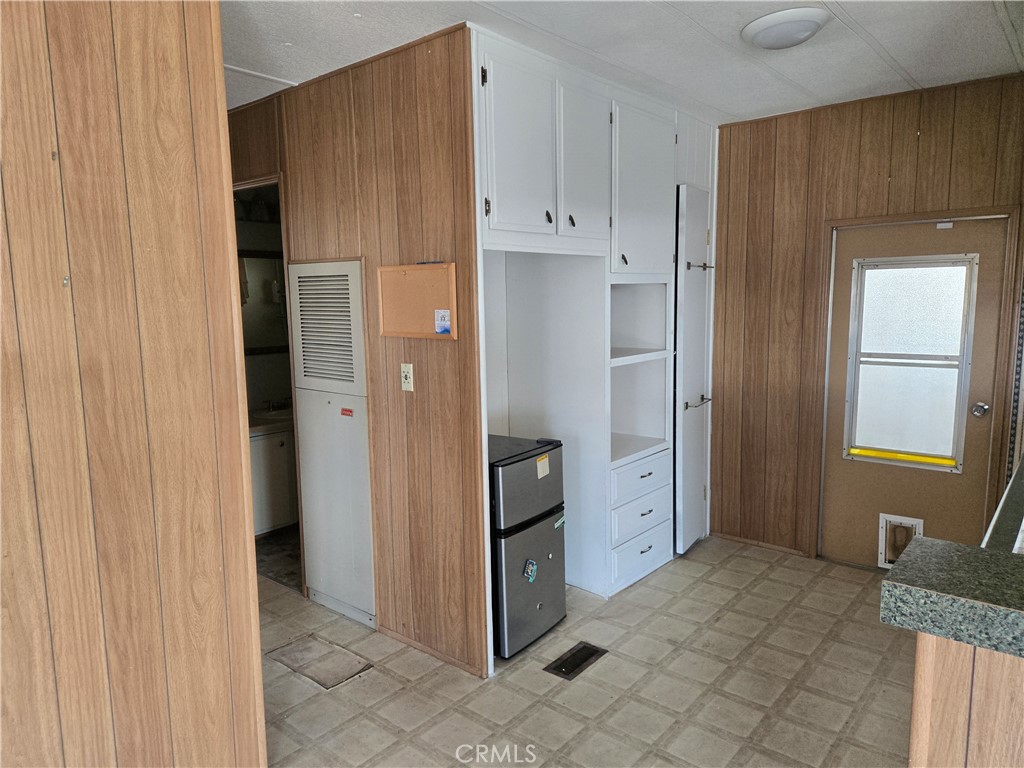 1700 State, Unit 56 Hemet, CA 92543 - Photo 3 of 10 a view of a kitchen with white cabinets and refrigerator