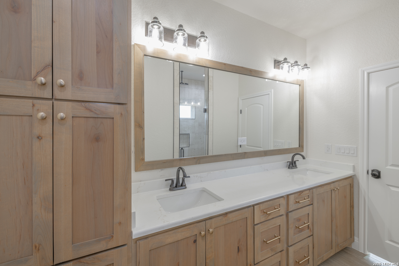 591 Eichman Road Poteet, TX 78065 - Photo 13 of 22 a bathroom with double vanity sink and a mirror