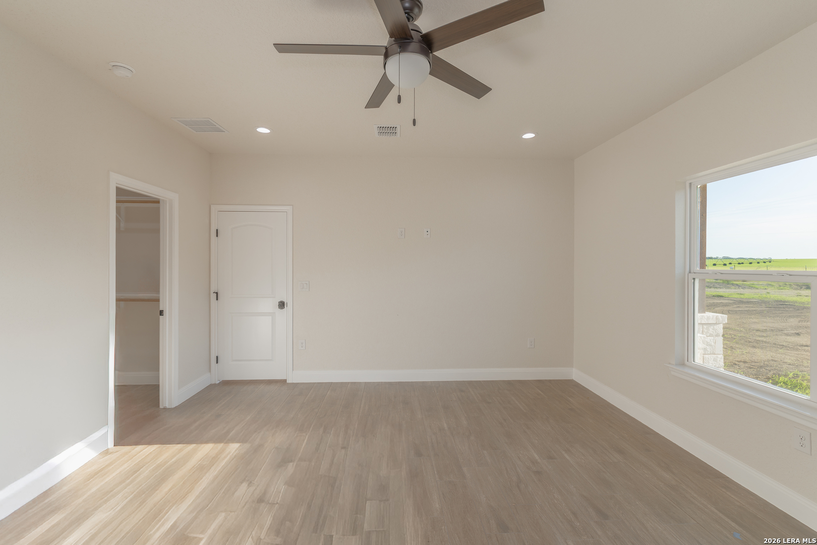 591 Eichman Road Poteet, TX 78065 - Photo 14 of 22 an empty room with a window and a ceiling fan