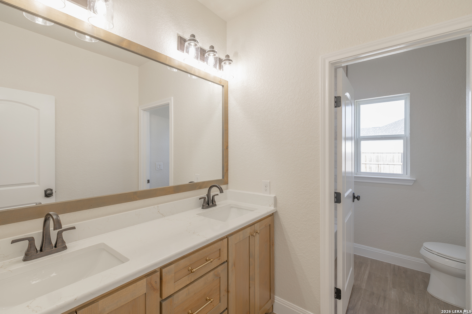 591 Eichman Road Poteet, TX 78065 - Photo 15 of 22 a bathroom with a sink and a mirror