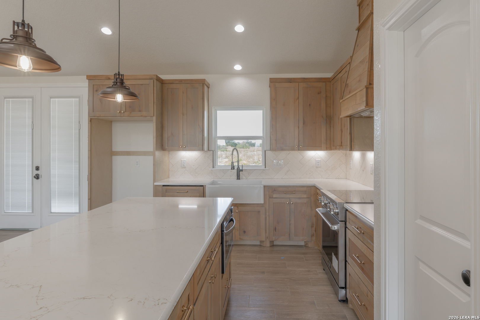 591 Eichman Road Poteet, TX 78065 - Photo 7 of 22 a kitchen with a sink stainless steel appliances and cabinets