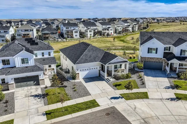 an aerial view of a house with a yard
