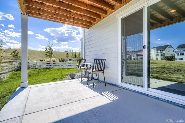 a view of a porch with a floor to ceiling window and a yard
