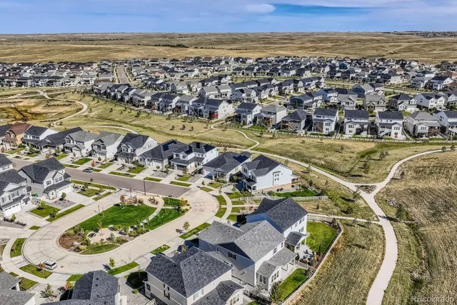 an aerial view of a house with a ocean view