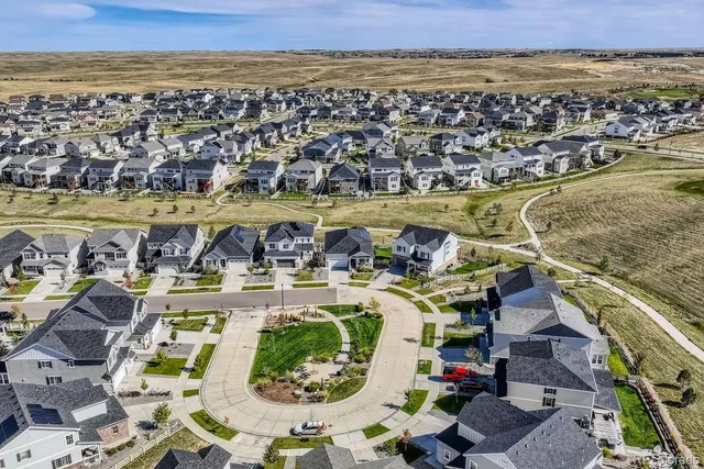 an aerial view of residential houses with outdoor space