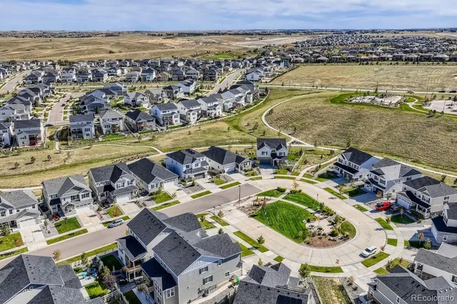an aerial view of residential houses with outdoor space