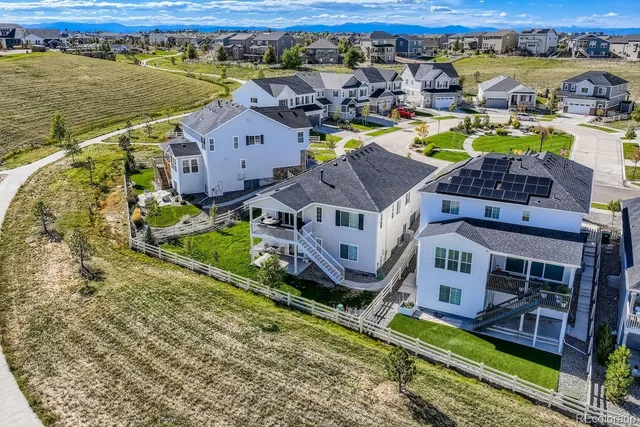 an aerial view of residential houses with outdoor space