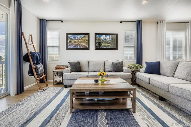 a living room with furniture and a rug