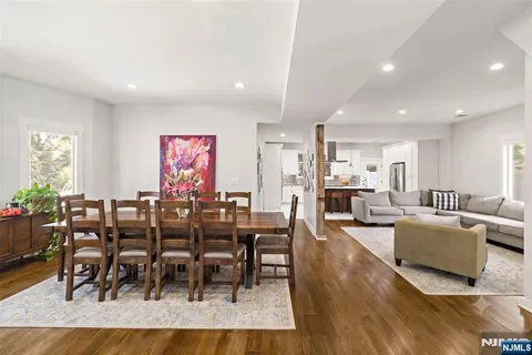 a kitchen with stainless steel appliances granite countertop a sink a stove and a refrigerator