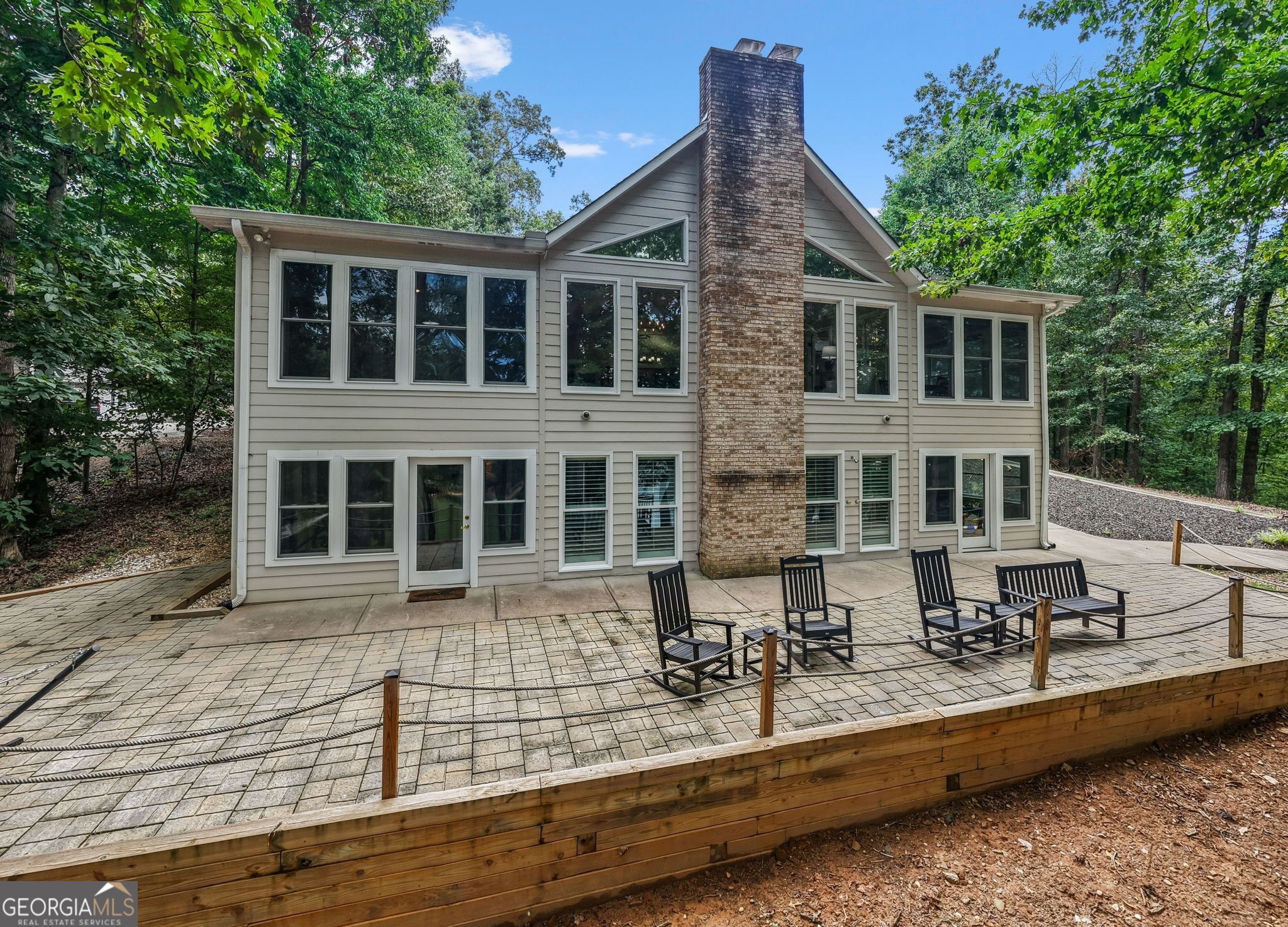 a view of house with a yard and sitting area