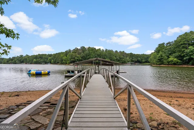 a living room with furniture a flat screen tv and a large window