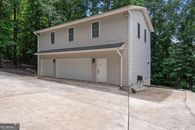 a kitchen with stainless steel appliances granite countertop a stove top oven a refrigerator a dining table and chairs with wooden floor