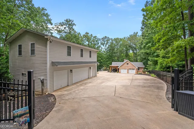 a kitchen with stainless steel appliances granite countertop a stove refrigerator a sink dishwasher a dining table and chairs with wooden floor