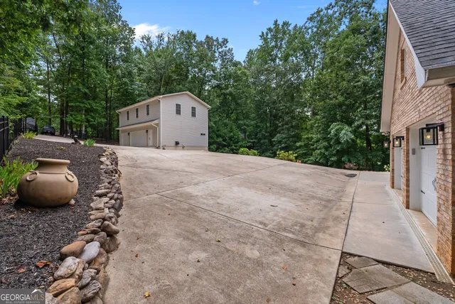 a bedroom with a bed a chandelier and a window