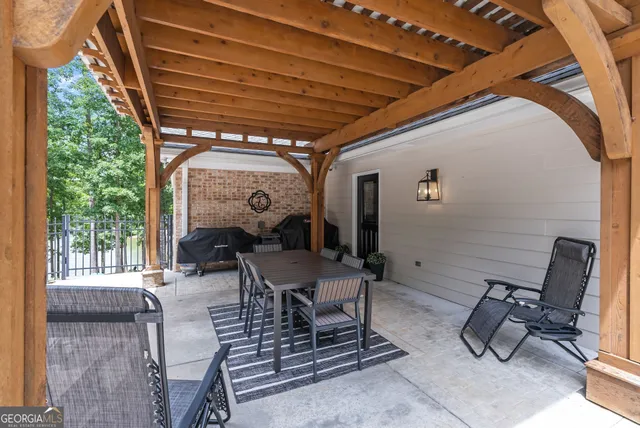 a bathroom with a granite countertop sink a toilet a mirror and shower
