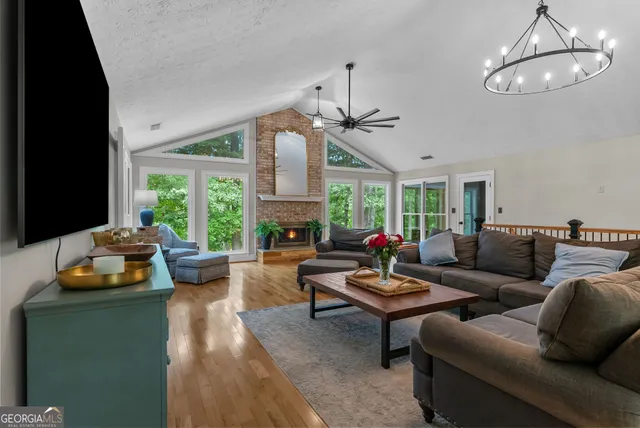 a living room with furniture a flat screen tv and a fireplace