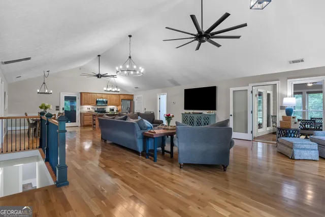 a view of a livingroom with furniture and a large window