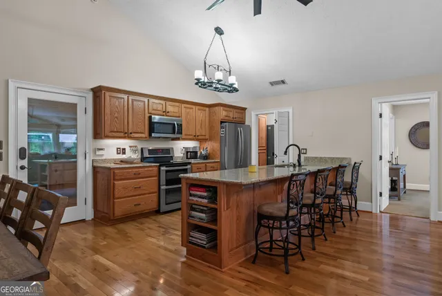a bedroom with a bed and a ceiling fan