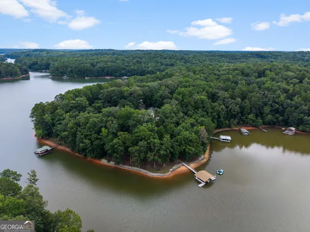 an aerial view of a house with a yard and lake view