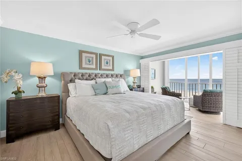 a bedroom with a large bed and a large window