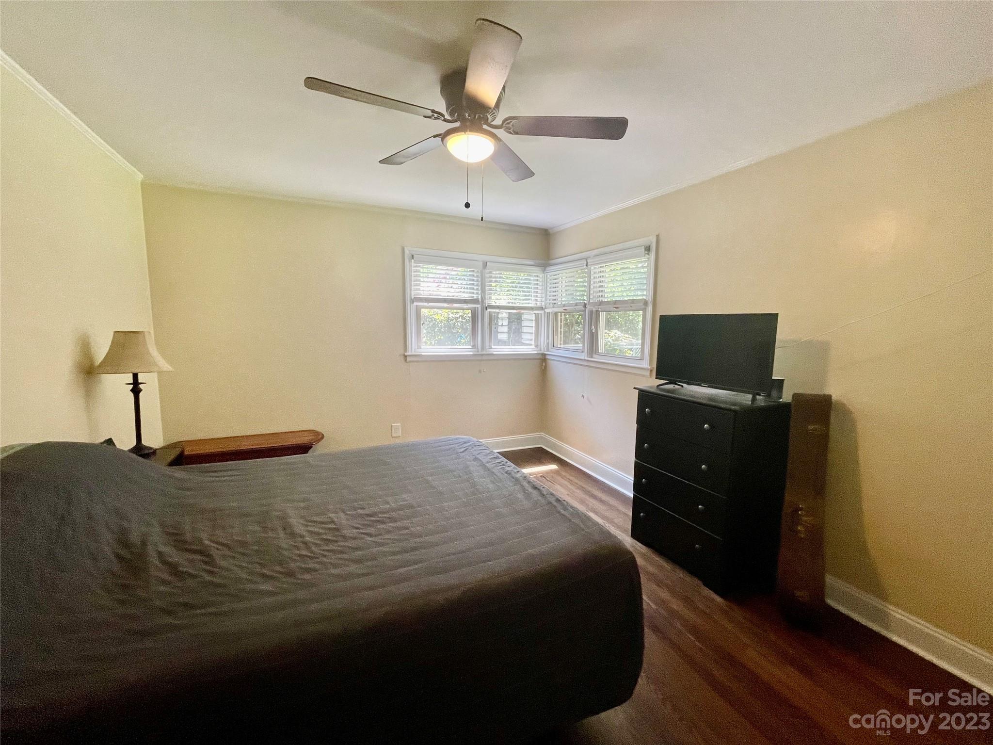 2224 Falmouth Road Charlotte, NC 28205 - Photo 8 of 13 a bedroom with a bed window and a ceiling fan