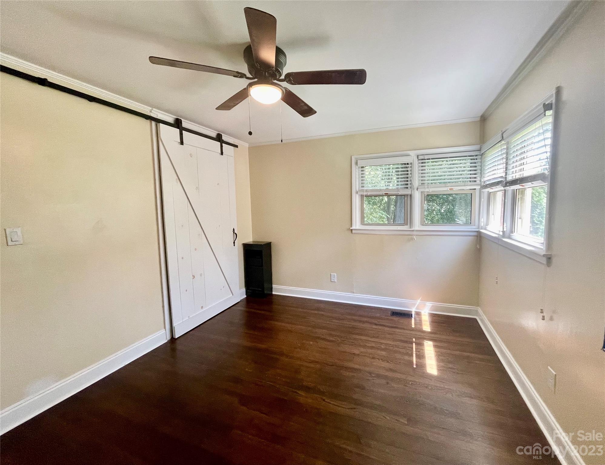 2224 Falmouth Road Charlotte, NC 28205 - Photo 9 of 13 a view of an empty room with wooden floor and a window