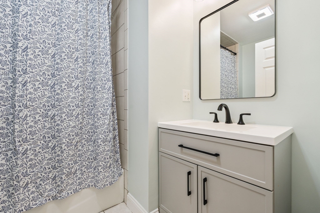 172 Cottage Street, Unit 2 Boston, MA 02128 - Photo 17 of 33 a bathroom with a sink and a mirror