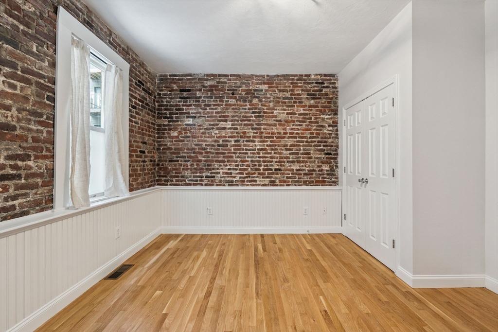 172 Cottage Street, Unit 2 Boston, MA 02128 - Photo 24 of 33 a view of empty room with wooden floor and fan