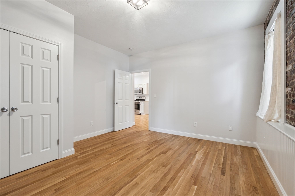 172 Cottage Street, Unit 2 Boston, MA 02128 - Photo 26 of 33 wooden floor in an empty room