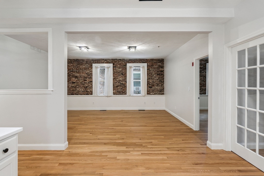 172 Cottage Street, Unit 2 Boston, MA 02128 - Photo 4 of 33 a view of an empty room with wooden floor and a window