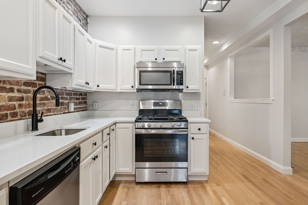 172 Cottage Street, Unit 2 Boston, MA 02128 - Photo 7 of 33 a kitchen with a stove and a sink