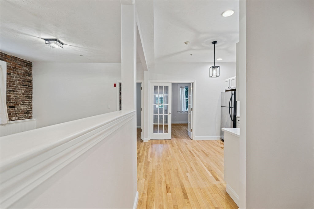 172 Cottage Street, Unit 2 Boston, MA 02128 - Photo 10 of 33 a view of a big room with wooden floor and windows