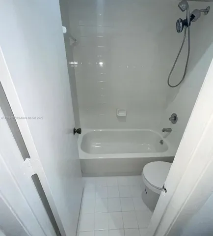 a bathroom with a bathtub a toilet and a shower