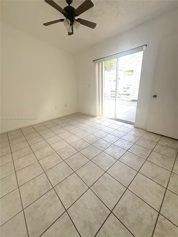 a view of an empty room and a window