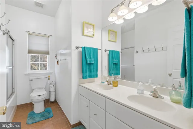 a bathroom with a sink vanity granite and a mirror