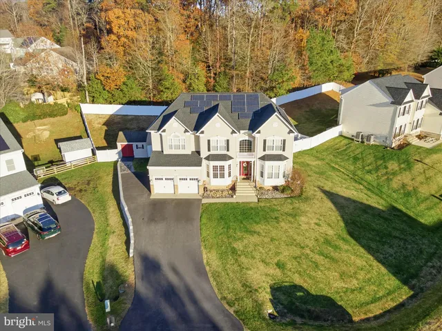 an aerial view of a house with a swimming pool